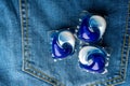 Washing detergent capsule pod on jeans Royalty Free Stock Photo