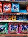 Washing detergents in commercial packaging on supermarket shelf.