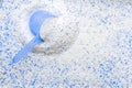 Washing detergents. White wash soap texture with cup for laundry background. Liquid powder in scoop for machine. Housekeeping and