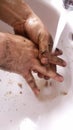 Washing dirty hands Royalty Free Stock Photo