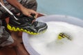 Washing the dirty shoes or sneakers.