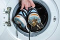 Washing dirty sneakers in the washing machine. Cleaning trail running shoes Royalty Free Stock Photo