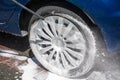 Washing a dirty wheel with a high pressure jet wash