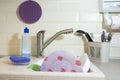 Washing dishes in the kitchen. Dirty dishes plates and glasses lie in the sink. Tender lilac plate front view Homework Royalty Free Stock Photo