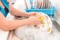 Washing the dishes on the kitchen sink