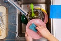 washing dishes. make hands in foam washes the dishes detergent and sponge in the kitchen of the house