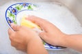 Washing the dishes on soapy water