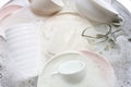 Washing dishes, utensils soaking in kitchen sink Royalty Free Stock Photo