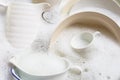 Washing dishes, utensils soaking in kitchen sink Royalty Free Stock Photo