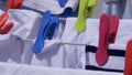 Brightly coloured clothes pegs on a washing line Royalty Free Stock Photo