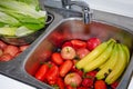 Washing of fruits and vegetables under kitchen sink to remove coronavirus covid-19