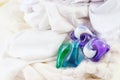 Washing gel capsule pods with laundry detergent on a pile of white cloth background, Capsule with laundry detergent on white Royalty Free Stock Photo