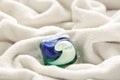 Washing gel capsule pods with laundry detergent on a pile of white cloth background, Capsule with laundry detergent on white Royalty Free Stock Photo