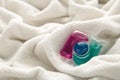 Washing gel capsule pods with laundry detergent on a pile of white cloth background, Capsule with laundry detergent on white Royalty Free Stock Photo