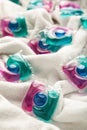 Washing gel capsule pods with laundry detergent on a pile of white cloth background, Capsule with laundry detergent on white Royalty Free Stock Photo