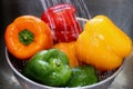 Washing green,yellow and red bell peppers Royalty Free Stock Photo