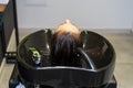 Washing hair on a blurred backdrop of a beauty salon. Background, selective focus Royalty Free Stock Photo