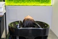Washing hair on a blurred backdrop of a beauty salon. Background, selective focus Royalty Free Stock Photo