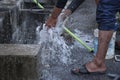 Washing hand,legs and plumbing tools with the burst water pipe splashing.