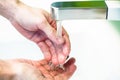 Washing hand under tap water