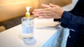 Washing hands by alcohol sanitizers from bottle