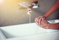 Washing hands, bathroom and person with water in home with soap for hygiene, bacteria or germs in morning. Faucet, sink Royalty Free Stock Photo