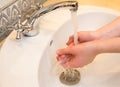 Washing hands in the bathroom sink. Frequent hand washing is a prerequisite for good hygiene in the face of the