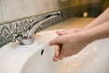 Washing hands in the bathroom sink. Frequent hand washing is a prerequisite for good hygiene in the face of the