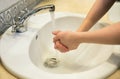 Washing hands in the bathroom sink. Frequent hand washing is a prerequisite for good hygiene in the face of the