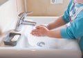 Washing hands child rinsing soap with running water at sink, Coronavirus prevention hand hygiene. Covid-19 pandemic protection by Royalty Free Stock Photo