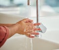 Washing hands, cleaning and person closeup with hygiene and water for wellness in kitchen. Soap, sink and home with Royalty Free Stock Photo