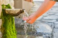 Washing hands in fresh, cold, potable source water on a mountain, Drinking Spring, Wooden Pipe of Fresh Potable, Unpolluted, Royalty Free Stock Photo