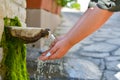 Washing hands in fresh, cold, potable source water on a mountain, Drinking Spring, Wooden Pipe of Fresh Potable, Unpolluted, Royalty Free Stock Photo