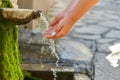 Washing hands in fresh, cold, potable source water on a mountain, Drinking Spring, Wooden Pipe of Fresh Potable, Unpolluted, Royalty Free Stock Photo