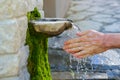 Washing hands in fresh, cold, potable source water on a mountain, Drinking Spring, Wooden Pipe of Fresh Potable, Unpolluted, Royalty Free Stock Photo