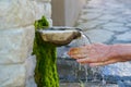 Washing hands in fresh, cold, potable source water on a mountain, Drinking Spring, Wooden Pipe of Fresh Potable, Unpolluted, Royalty Free Stock Photo