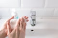 Washing hands with gentle soap foam over the sink in the bathroom, indoors. Concept healthcare