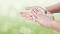 Washing hands. Hygiene concept. Green bokeh background.