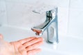 Washing hands person for coronavirus prevention, hygiene to stop spreading covid-19 in bathroom. Washing hands under