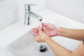 Washing hands with soap under the faucet with clean water. Royalty Free Stock Photo