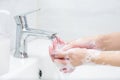 Washing hands with soap under the faucet with water Royalty Free Stock Photo