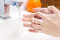 Washing of hands with soap under running water in white sink. close - up. antivirus protection wash your hands. Royalty Free Stock Photo