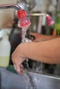 Washing hands under flowing tap water Kitchen porter washing his hands in professional kitchen Royalty Free Stock Photo