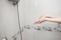Washing hands under the shower in a bright bathroom. The girl washes and takes care of her body. Royalty Free Stock Photo