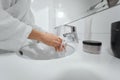 Washing hands in white bathroom. Royalty Free Stock Photo