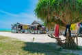 Washing hanging from tree in shade in front stilt shack homes in  tropical island Royalty Free Stock Photo