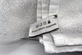 Washing instructions clothes label on white cotton as a background. Royalty Free Stock Photo