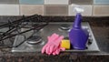Rubber glove wash kit, sponge, detergent on a gas stove
