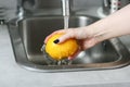 washing lemon in the sink