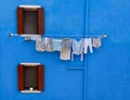 Washing line on a blue house Royalty Free Stock Photo